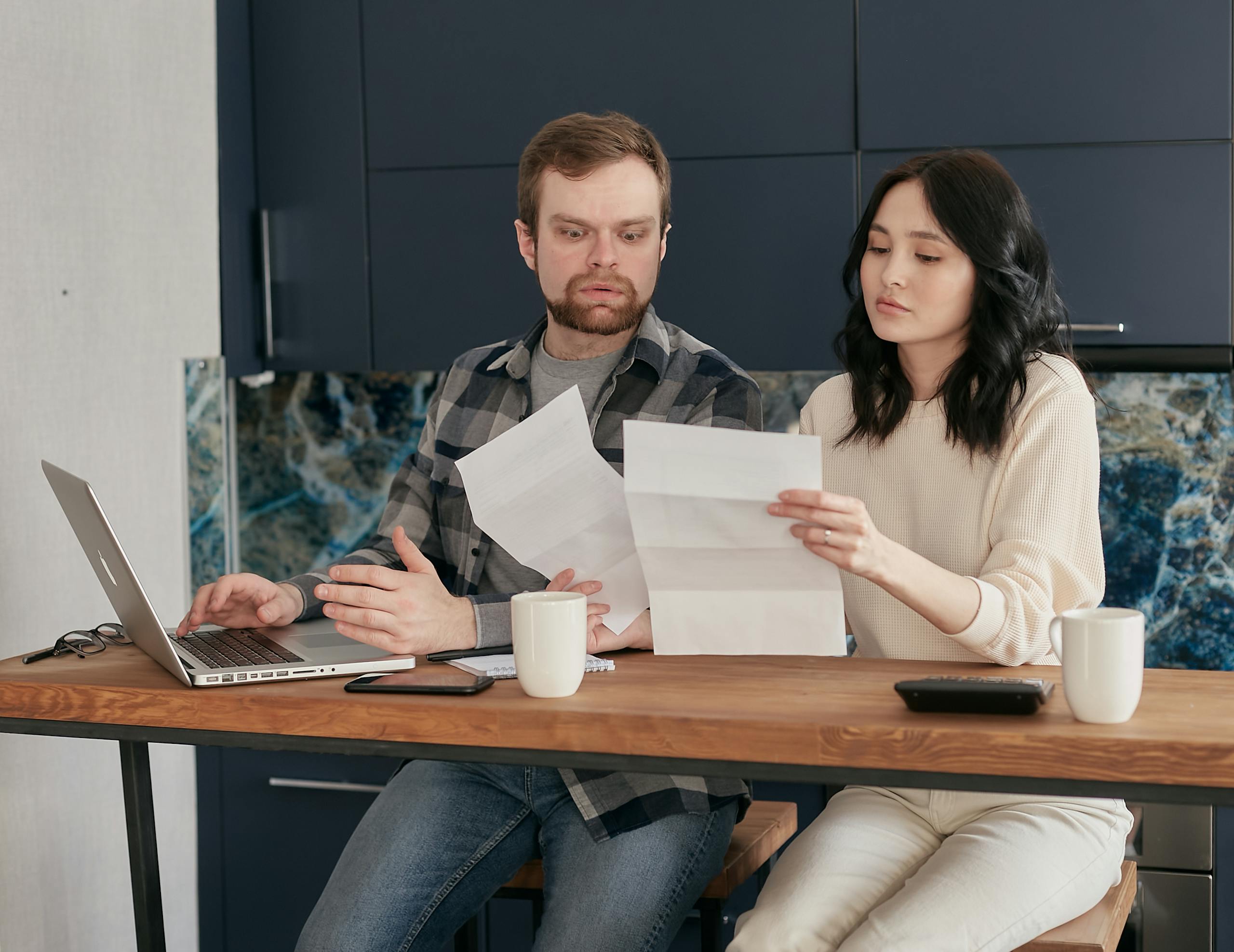 A Woman Holding Papers Sitting Beside a Shocked Man