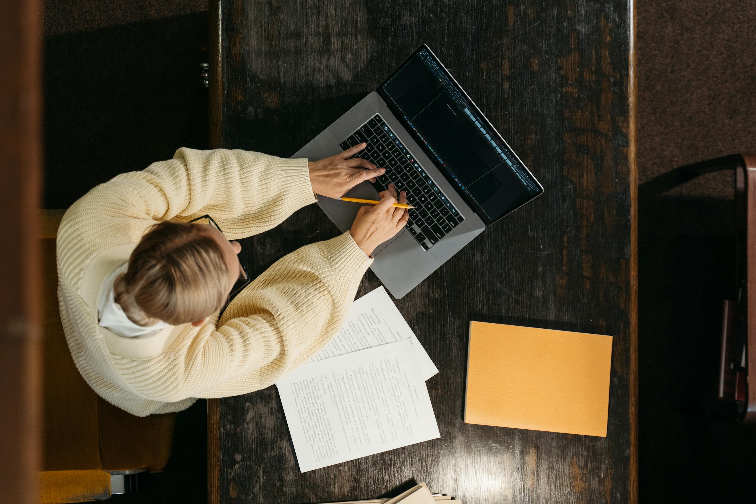 High-Angle Shot of a Person Using a Laptop